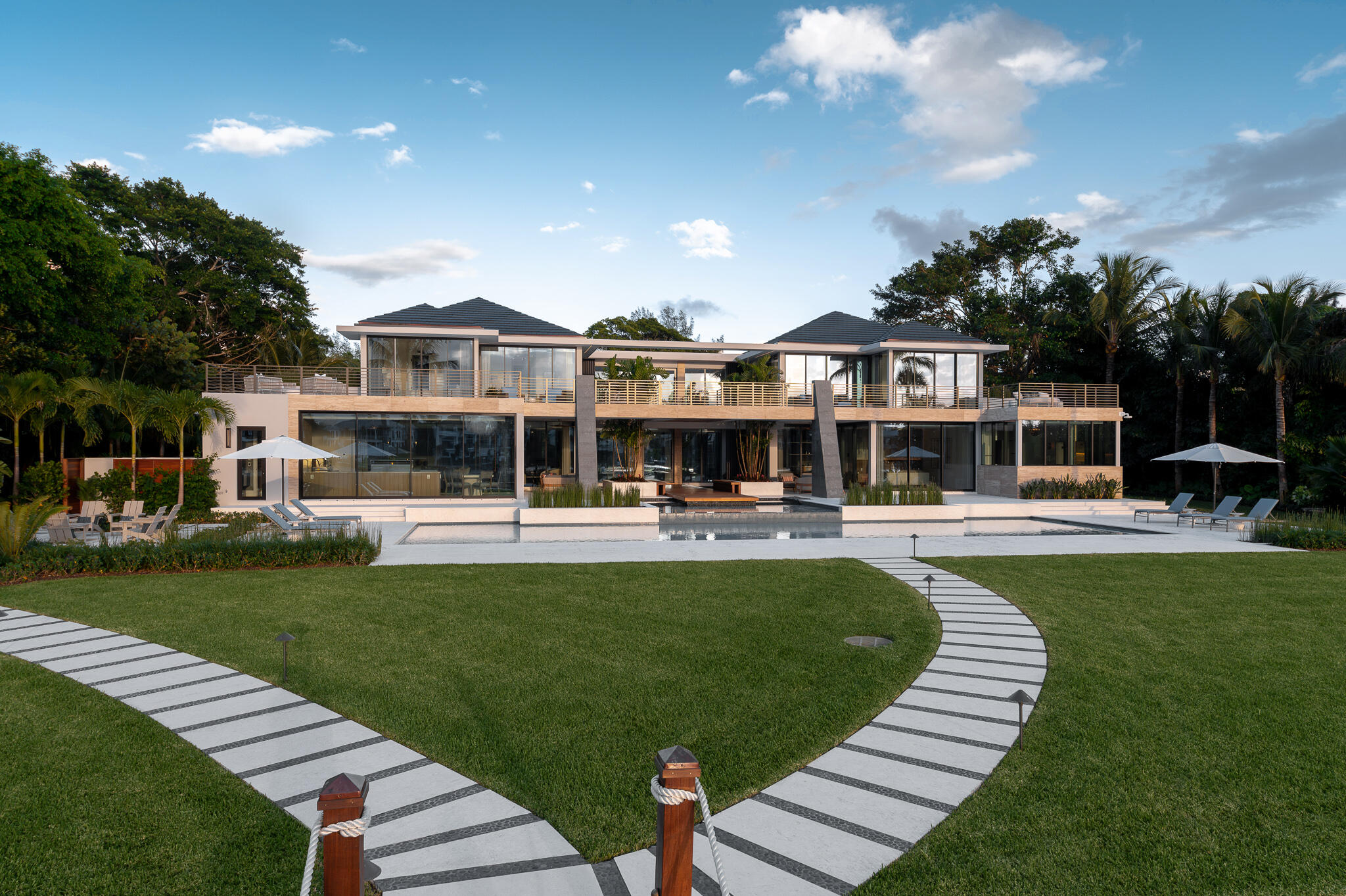488 South Beach Road Jupiter Island, FL 33455 - Photo 45 of 54 a front view of a house with garden and patio