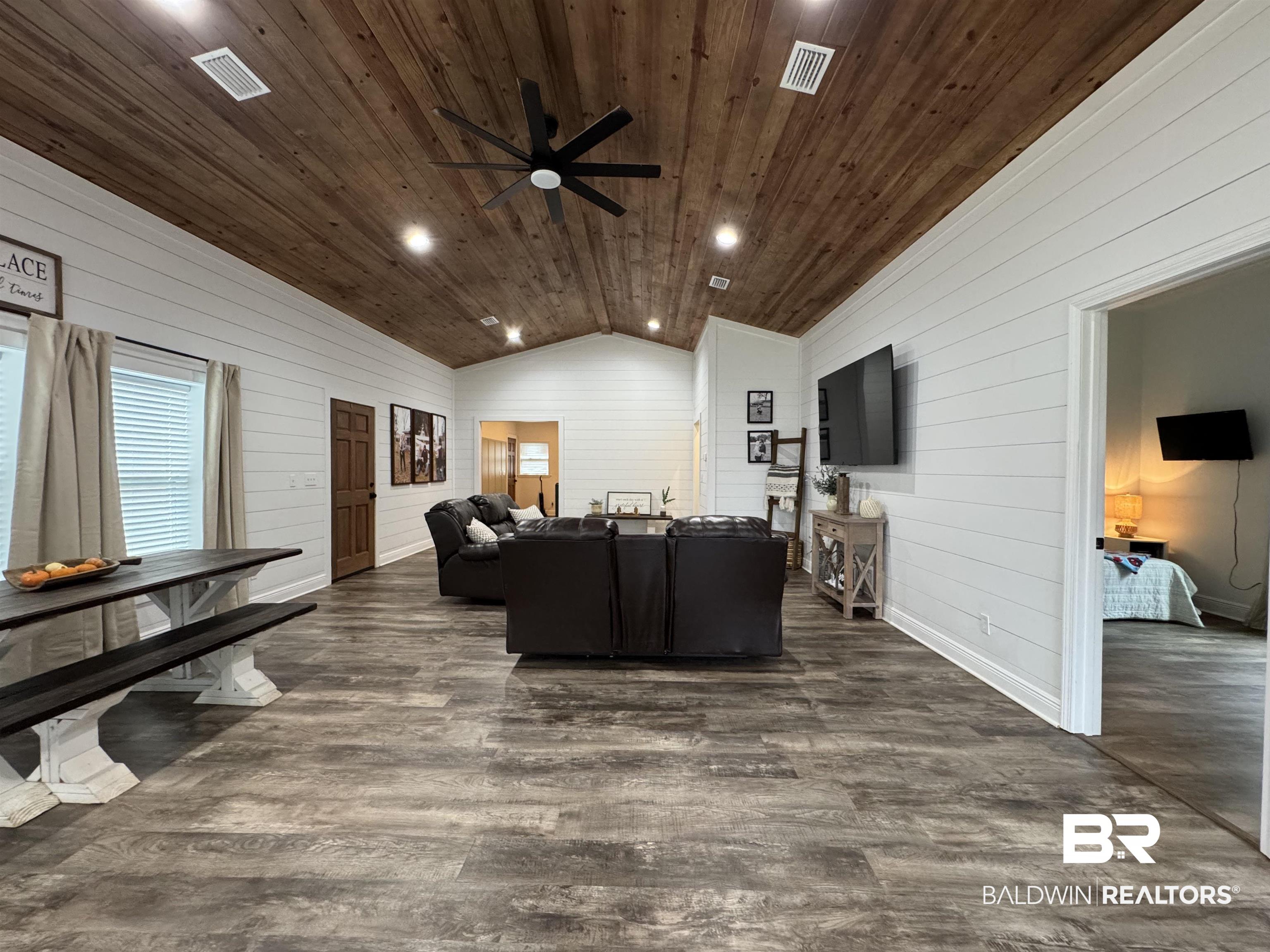 370 Dianne Road Frisco City, AL 36445 - Photo 17 of 41 Living room featuring dark hardwood / wood-style floors, a wealth of natural light, vaulted ceiling, wooden ceiling, and ceiling fan