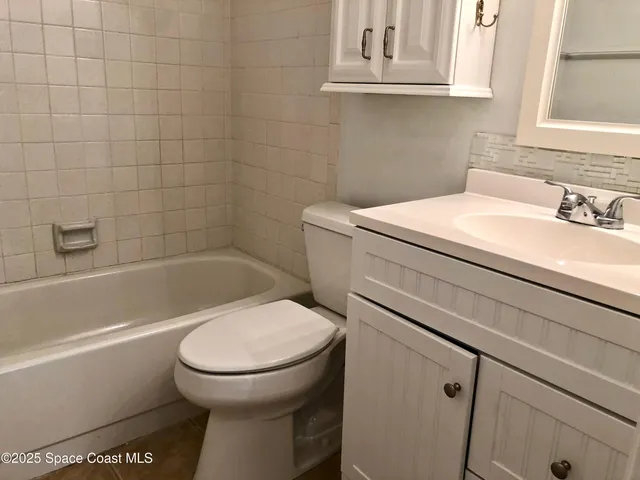 a bathroom with a sink a toilet and bathtub