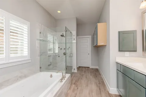 a bathroom with a bathtub and a sink