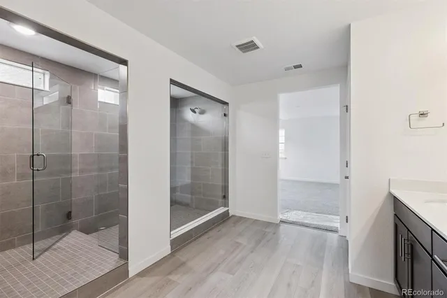 a bathroom with a shower and a glass door