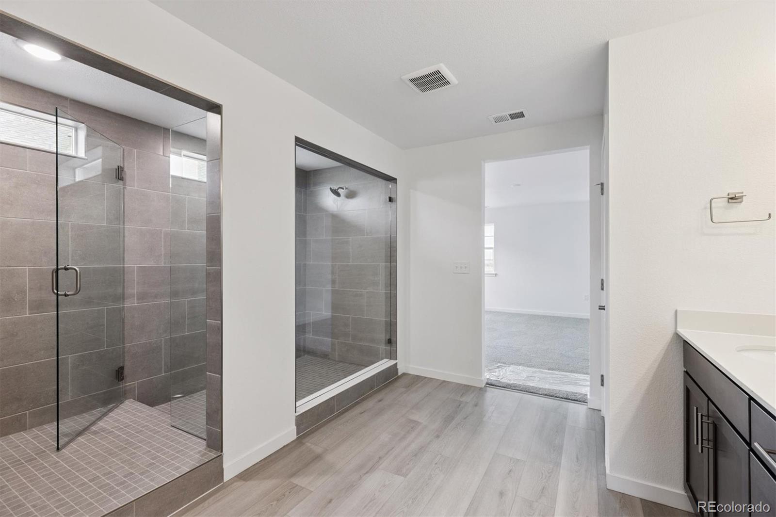 2144 South Ider Way Aurora, CO 80018 - Photo 20 of 27 a bathroom with a shower and a glass door