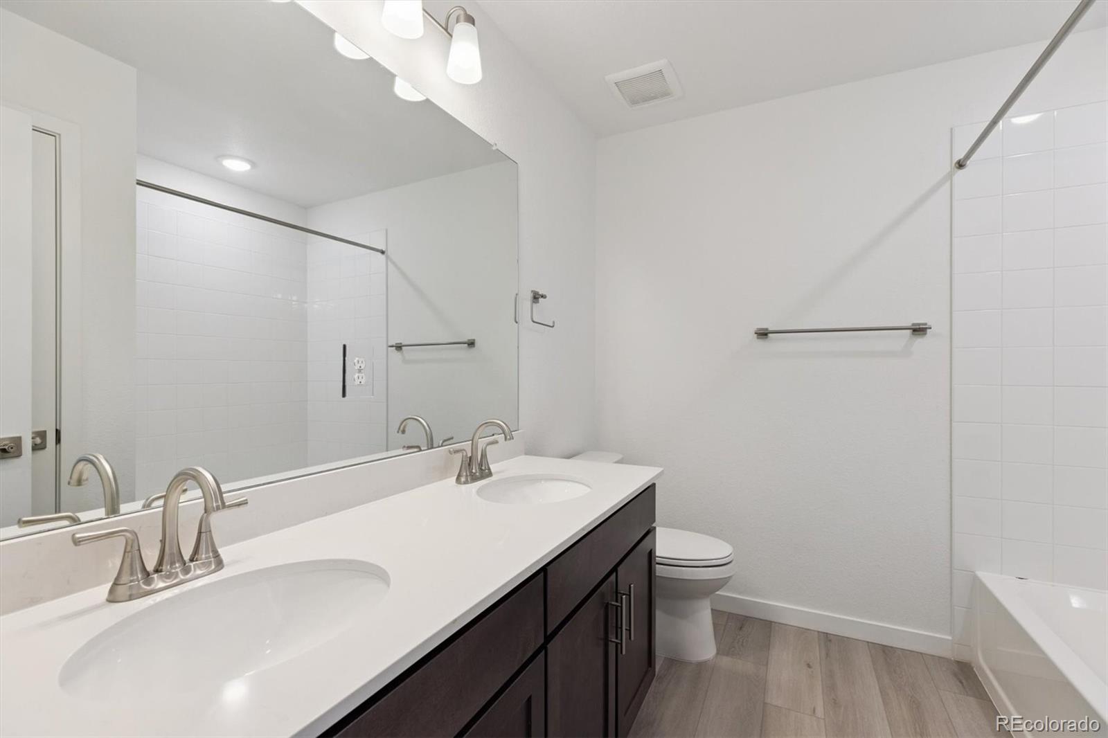 2144 South Ider Way Aurora, CO 80018 - Photo 23 of 27 a bathroom with a sink a toilet and shower