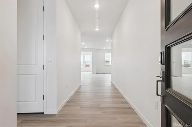 a view of a hallway with wooden floor