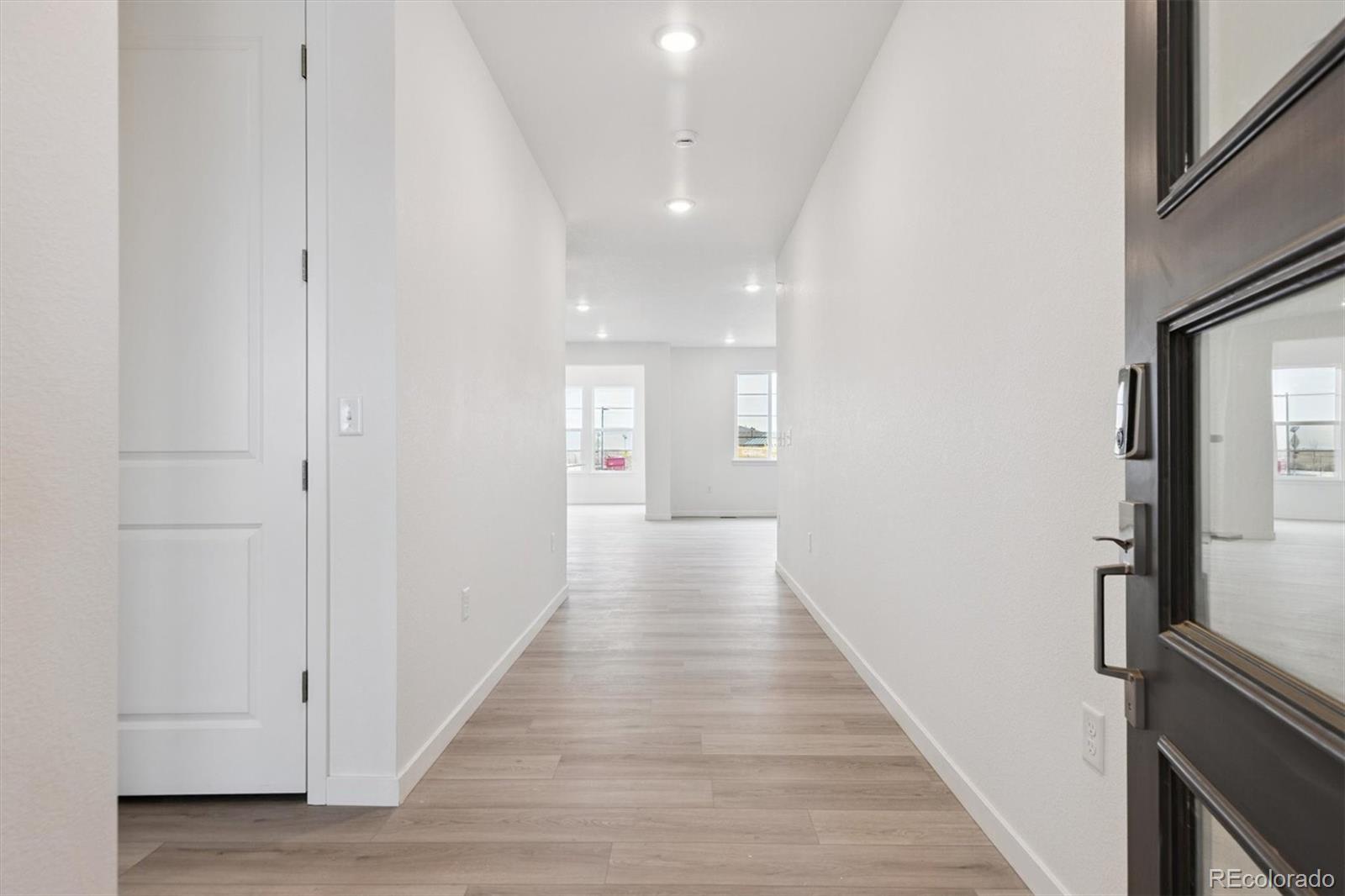 2144 South Ider Way Aurora, CO 80018 - Photo 3 of 27 a view of a hallway with wooden floor