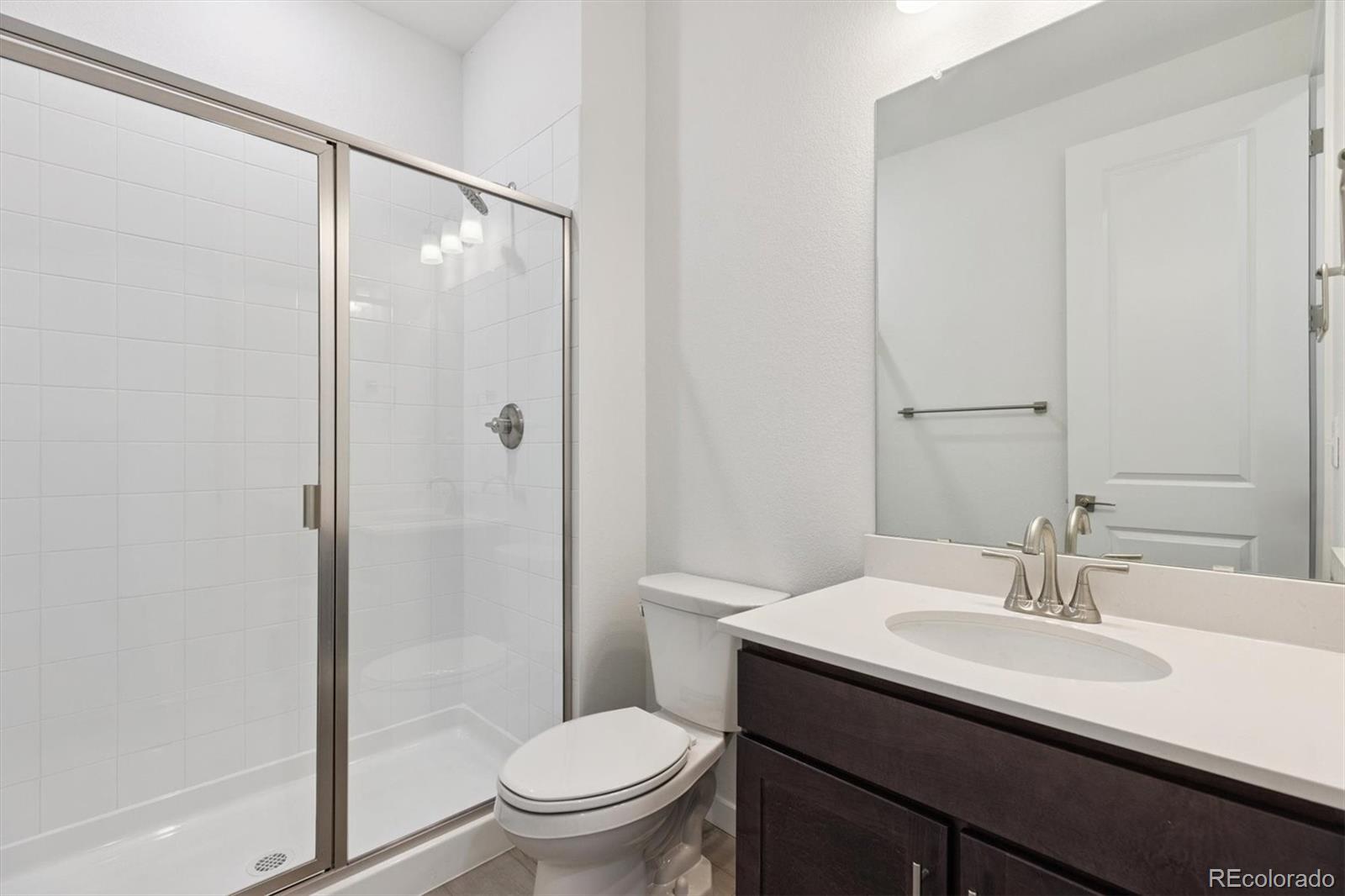 2144 South Ider Way Aurora, CO 80018 - Photo 6 of 27 a bathroom with a sink toilet and shower