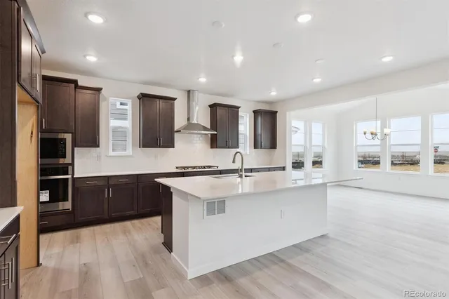 a large kitchen with stainless steel appliances kitchen island granite countertop a large counter top stainless steel appliances and cabinets