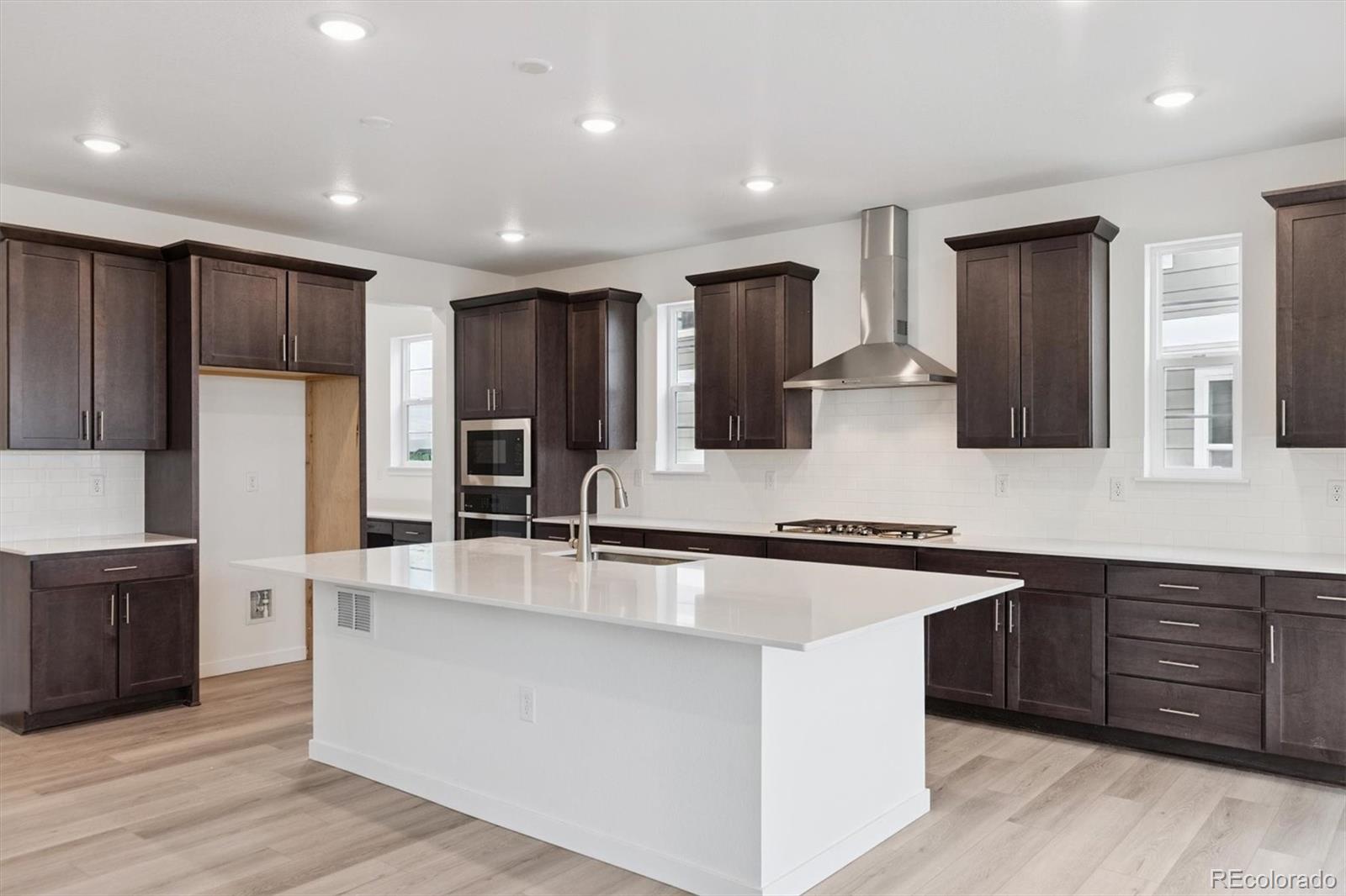 2144 South Ider Way Aurora, CO 80018 - Photo 10 of 27 a large kitchen with stainless steel appliances lots of counter space and a sink