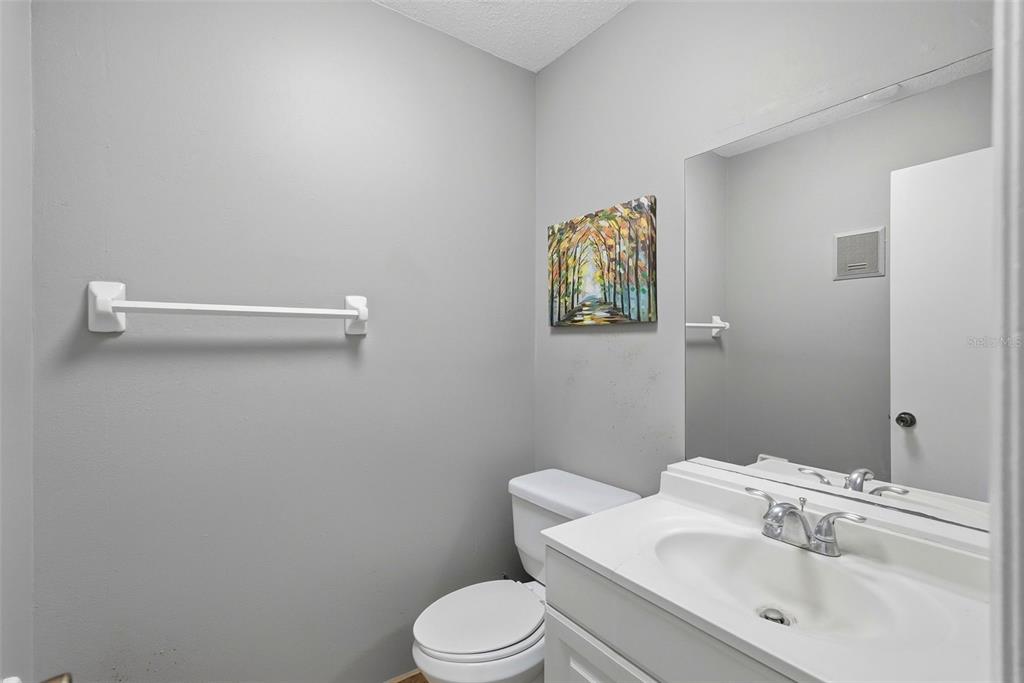 11709 Raintree Village Boulevard, Unit C Temple Terrace, FL 33617 - Photo 9 of 23 a bathroom with a sink mirror vanity and toilet