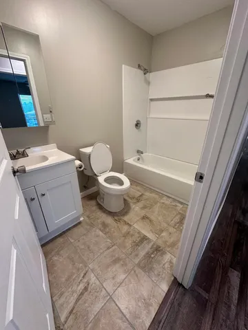 a dining room with wooden floor a chandelier a wooden table and chairs