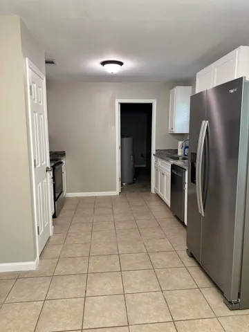 a kitchen with a refrigerator a microwave and a sink