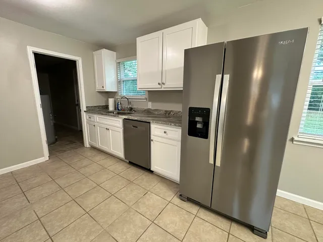 an empty room with a ceiling fan and window