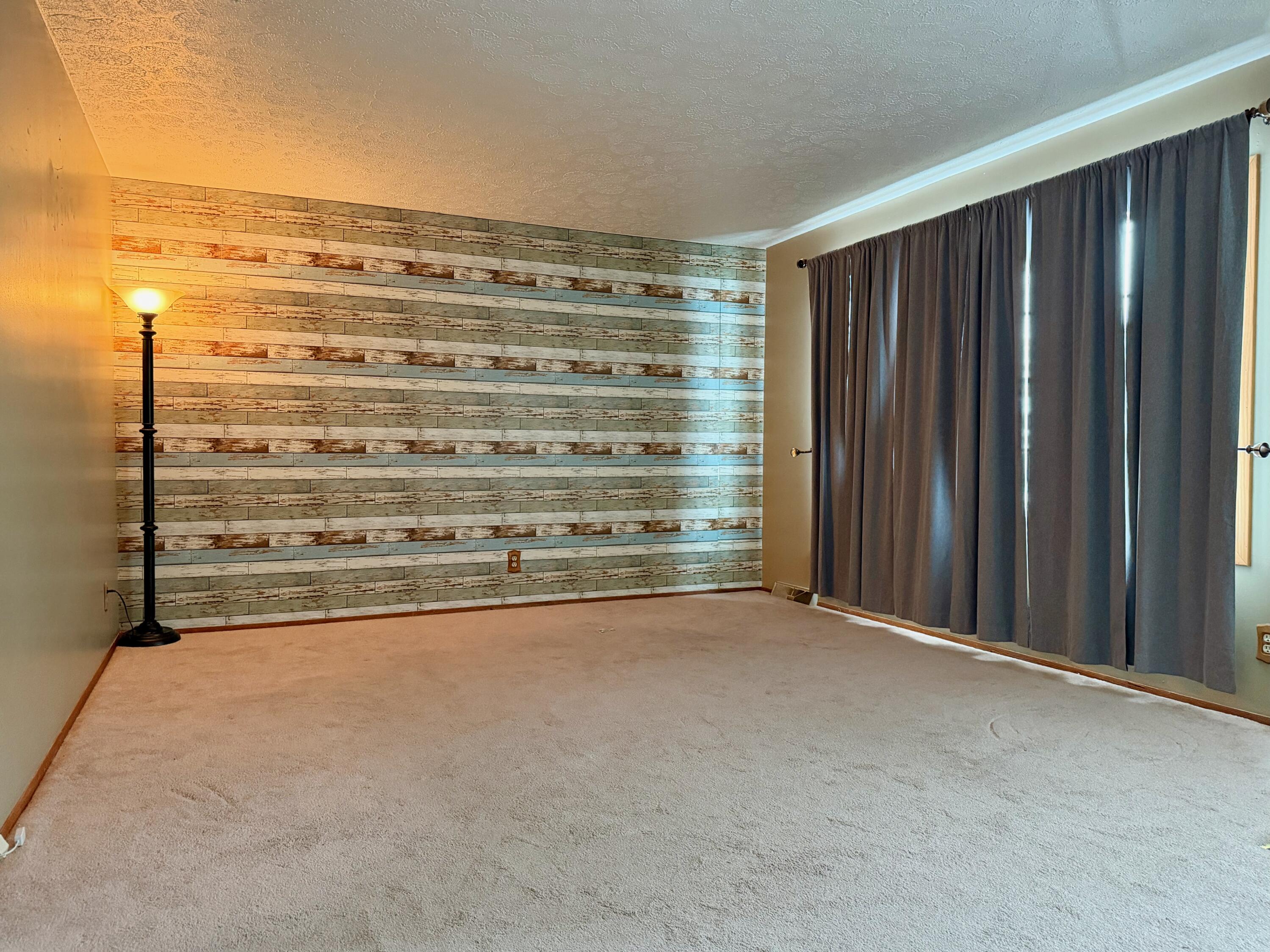 402 East St Louis Street Knox, IN 46534 - Photo 2 of 19 a view of an empty room with a wooden door