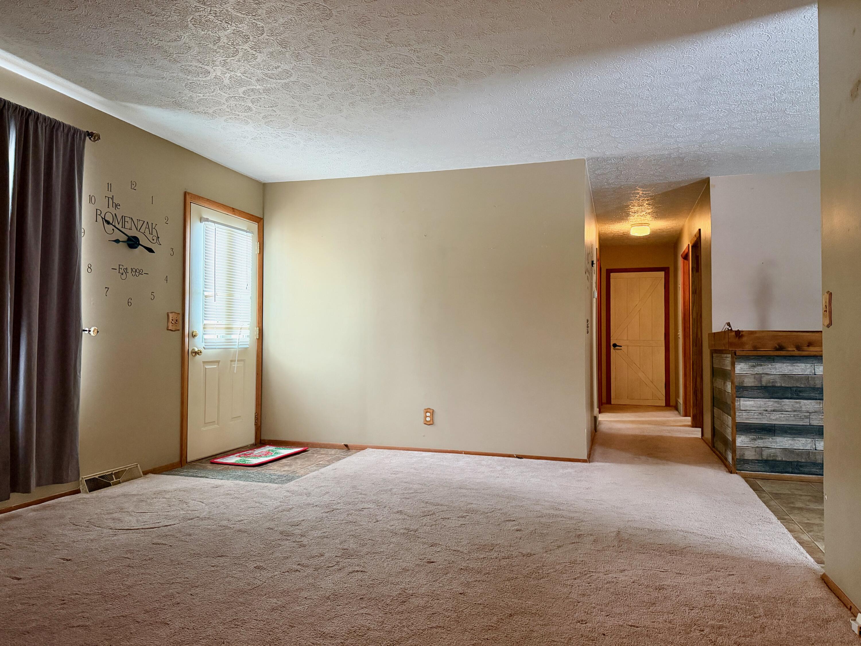 402 East St Louis Street Knox, IN 46534 - Photo 3 of 19 a view of an empty room with a cabinet