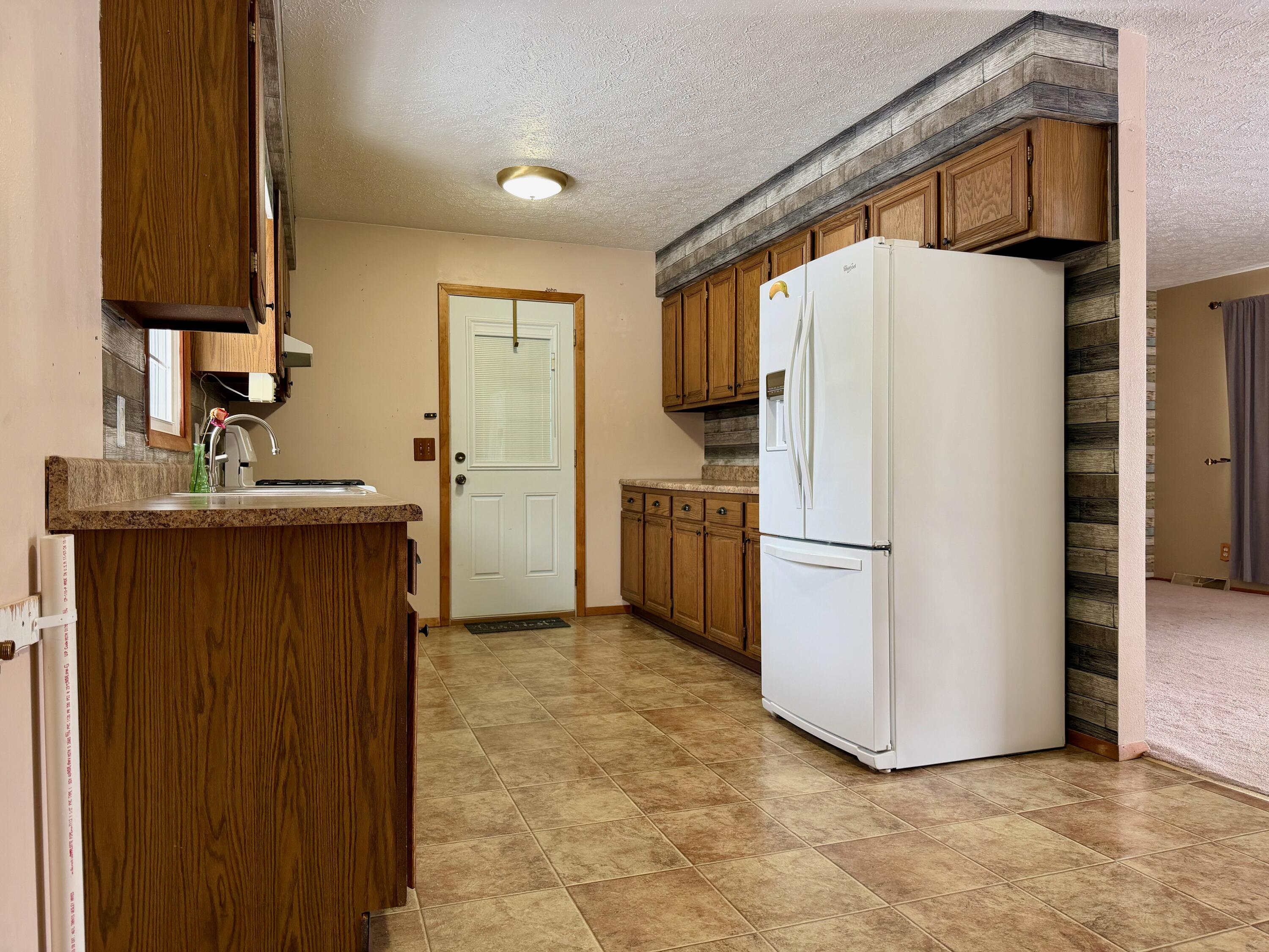 402 East St Louis Street Knox, IN 46534 - Photo 4 of 19 a white refrigerator freezer sitting in a kitchen