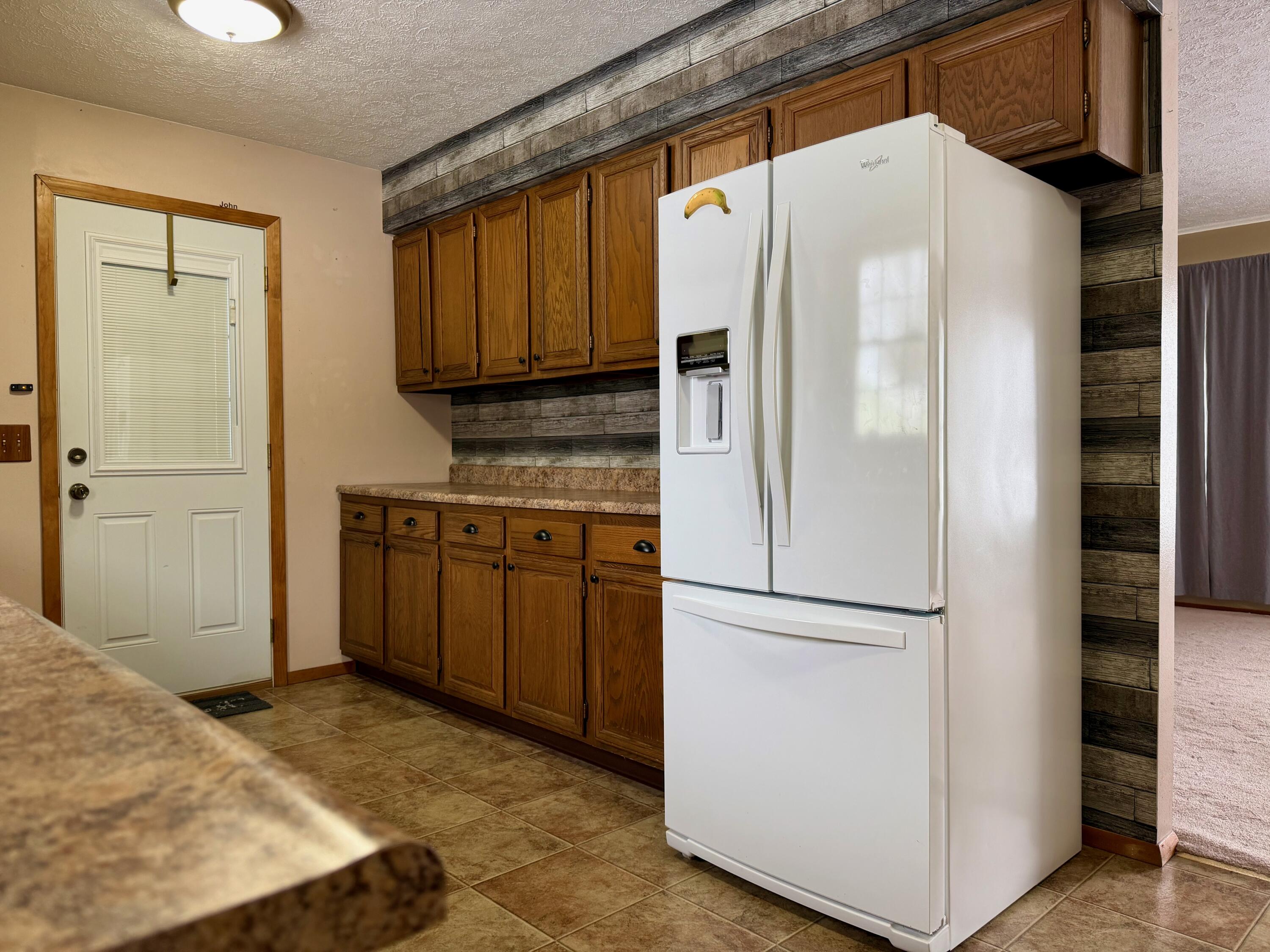 402 East St Louis Street Knox, IN 46534 - Photo 6 of 19 a kitchen with stainless steel appliances granite countertop a refrigerator and a stove