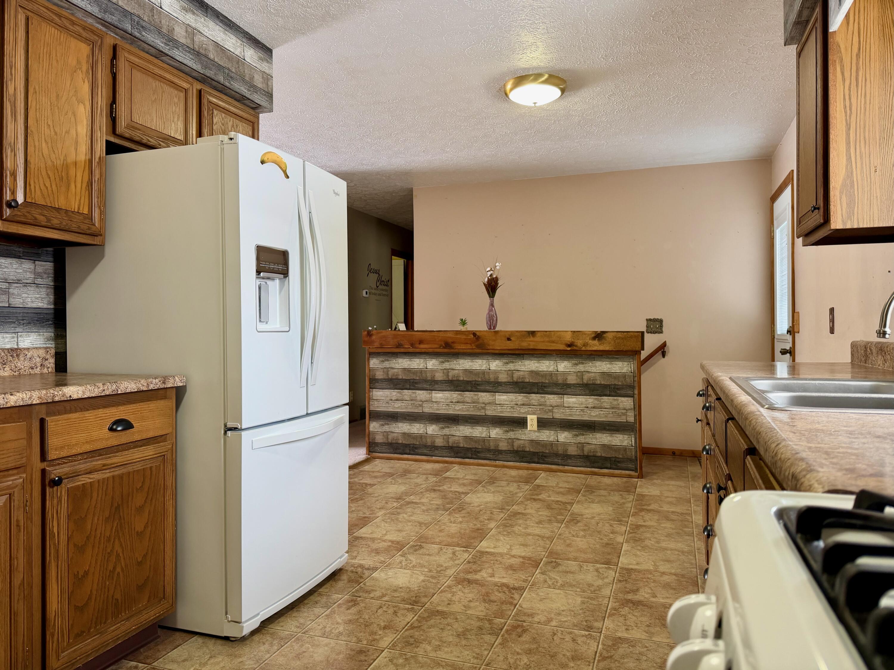 402 East St Louis Street Knox, IN 46534 - Photo 7 of 19 a kitchen with refrigerator and stove