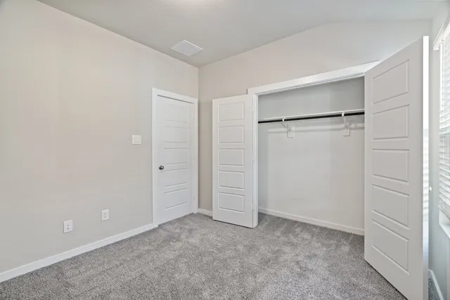 an empty room with closet area