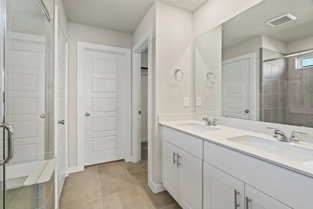a spacious bathroom with a granite countertop sink mirror and double