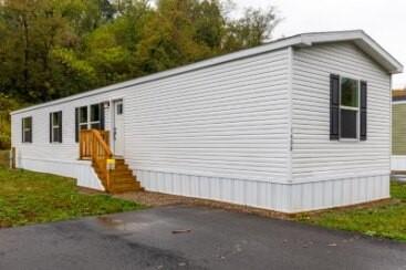 a view of a house with a yard and a garage