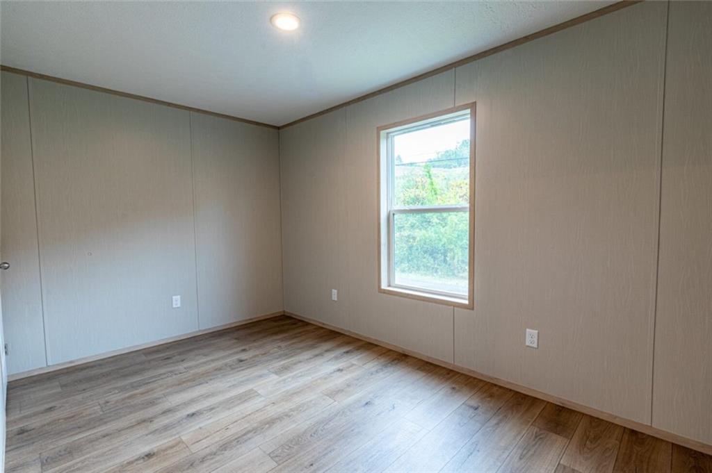 1408 A Hidden Valley Road Bulger, PA 15019 - Photo 21 of 22 an empty room with wooden floor and windows
