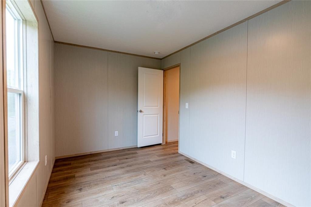 1408 A Hidden Valley Road Bulger, PA 15019 - Photo 22 of 22 an empty room with wooden floor and windows with curtains