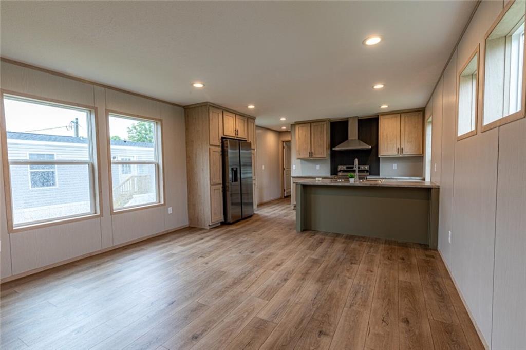 1408 A Hidden Valley Road Bulger, PA 15019 - Photo 5 of 22 a kitchen with stainless steel appliances granite countertop a refrigerator a sink dishwasher a stove and a large countertops with wooden floor