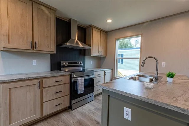 a kitchen with granite countertop a stove and a sink