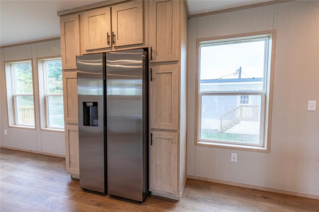 1408 A Hidden Valley Road Bulger, PA 15019 - Photo 9 of 22 a kitchen with metallic refrigerator and wooden floor