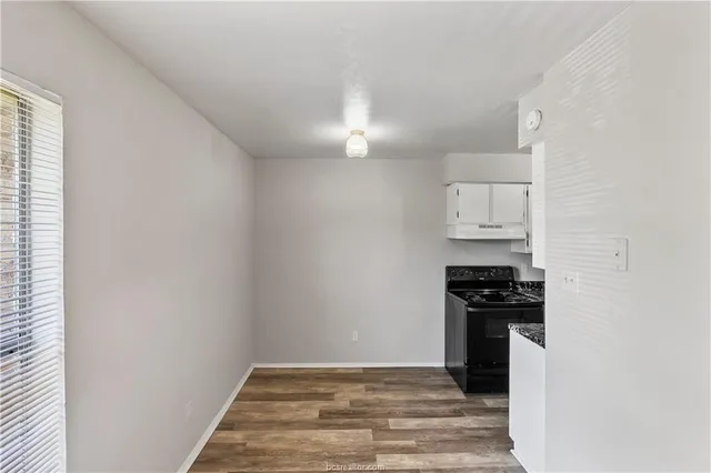 a kitchen with granite countertop a stove and a refrigerator