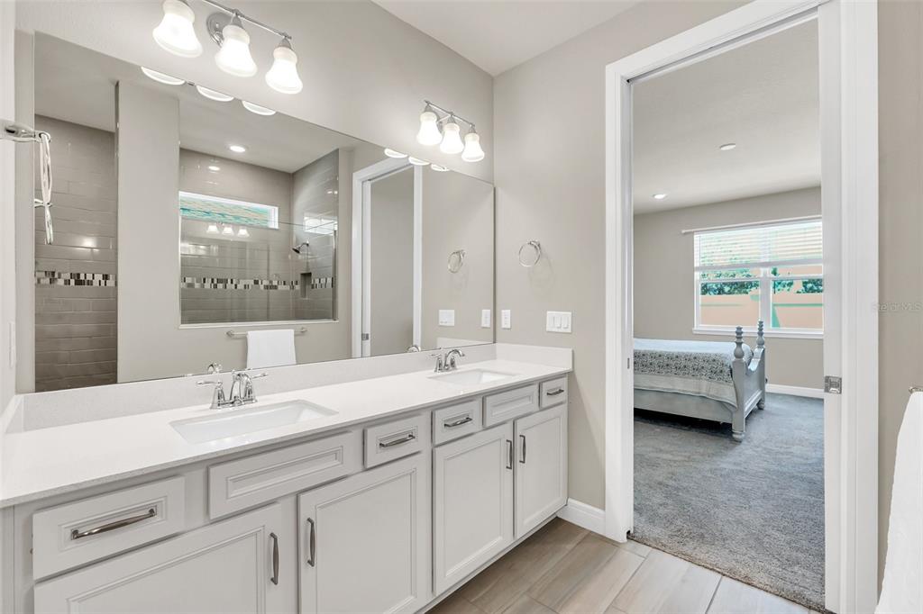 2001 Spring Shower Circle Kissimmee, FL 34744 - Photo 15 of 25 a en suite bathroom with double sink a large mirror and vanity