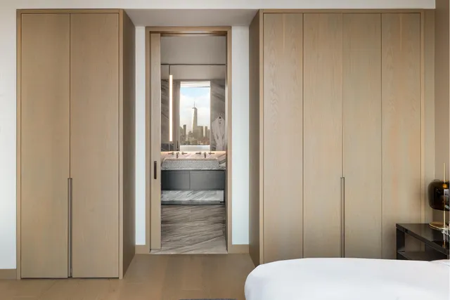 a room with a bed and a large window with outer view