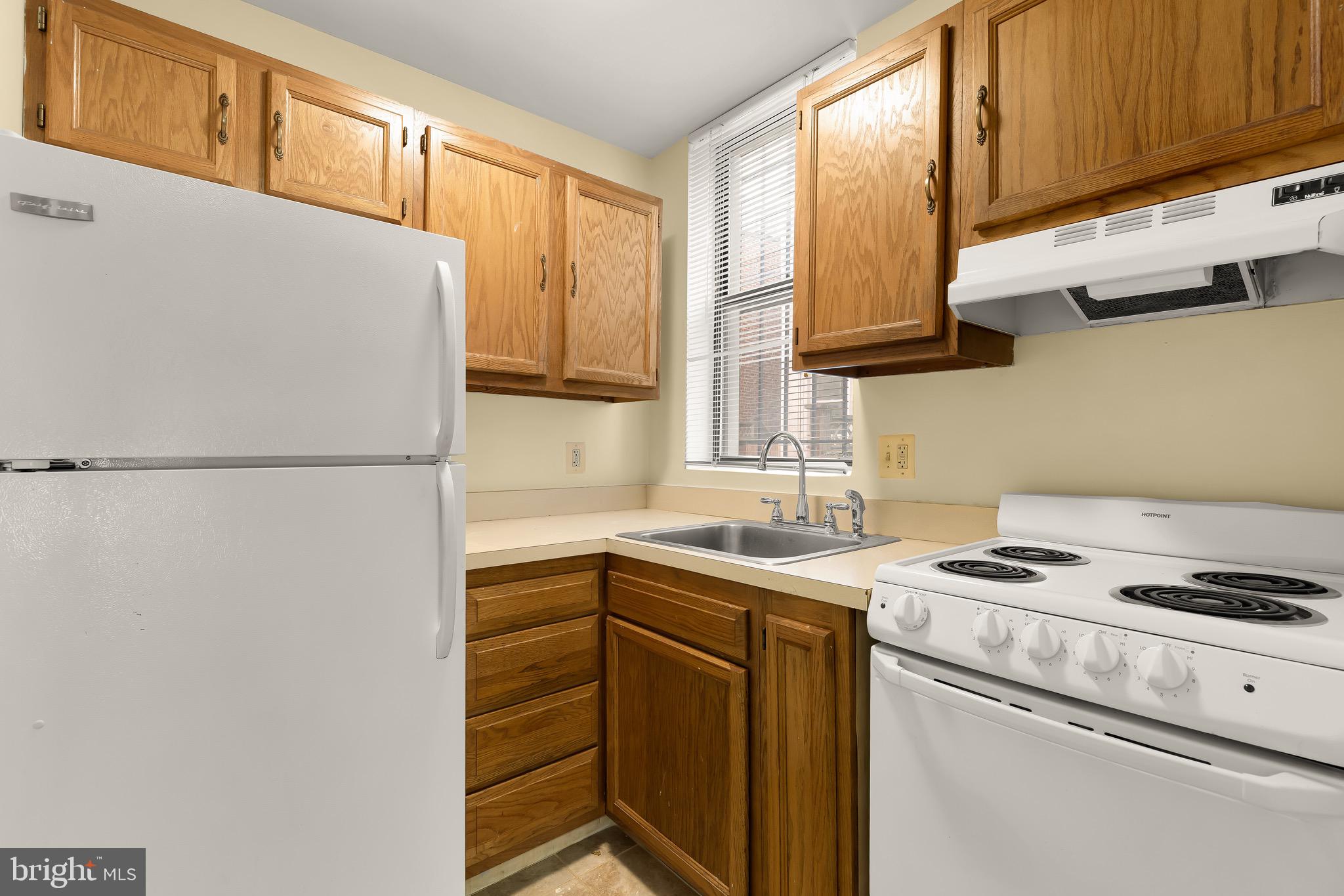 1768 Florida Avenue Northwest, Unit 1 Washington, DC 20009 - Photo 10 of 18 a kitchen with stainless steel appliances granite countertop a sink stove and refrigerator