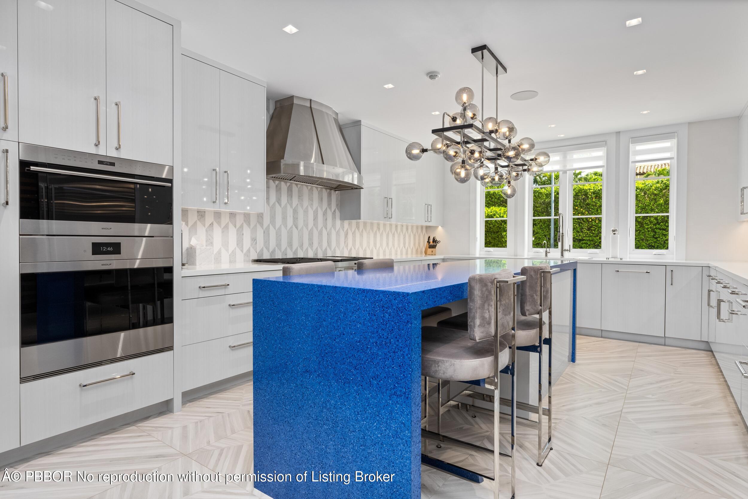 201 Banyan Road Palm Beach, FL 33480 - Photo 16 of 42 a kitchen with stainless steel appliances kitchen island granite countertop a stove a sink a microwave and a dining table