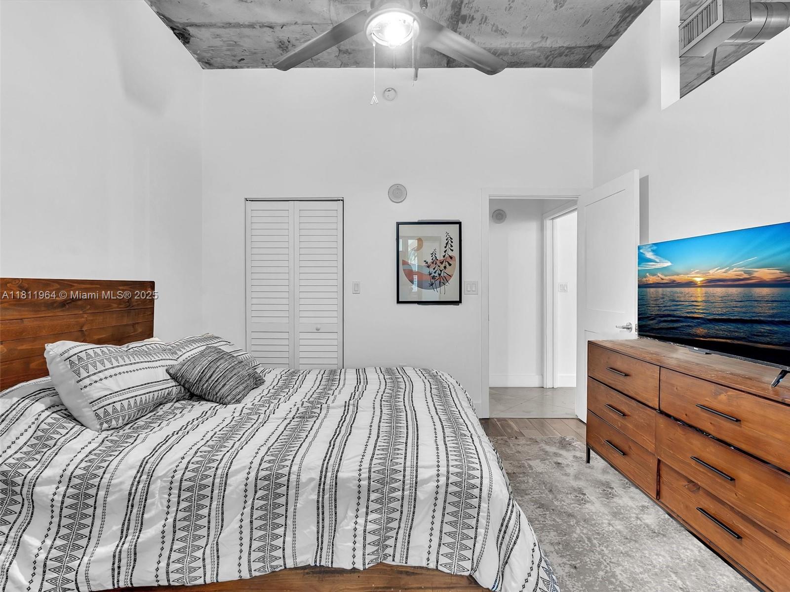 2001 Biscayne Boulevard, Unit 3205 Miami, FL 33137 - Photo 13 of 33 a bedroom with a bed and a flat screen tv