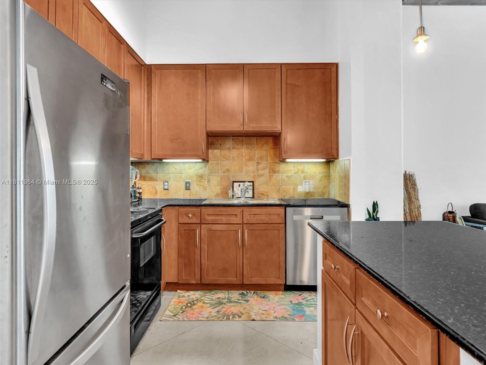 2001 Biscayne Boulevard, Unit 3205 Miami, FL 33137 - Photo 5 of 33 a kitchen with granite countertop a refrigerator stove and sink