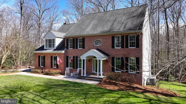 a front view of a house with a yard table and chairs