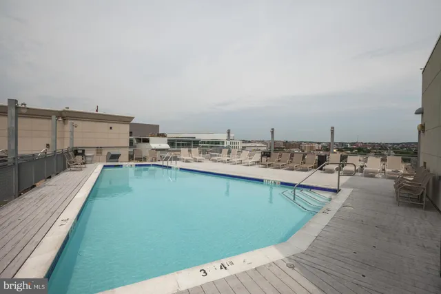 a view of a swimming pool with outdoor seating