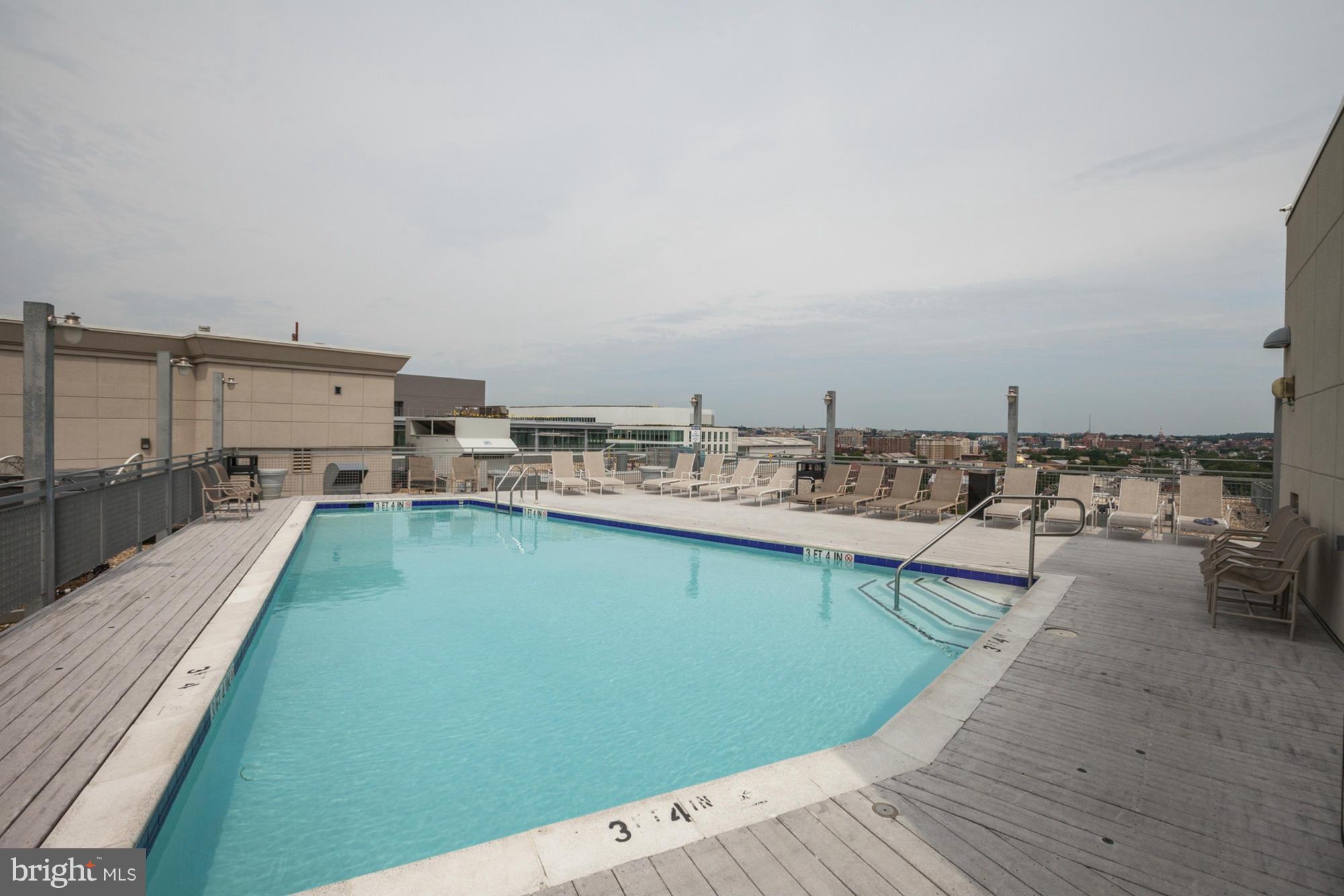 555 Massachusetts Avenue Northwest, Unit 806 Washington, DC 20001 - Photo 17 of 22 a view of a swimming pool with outdoor seating