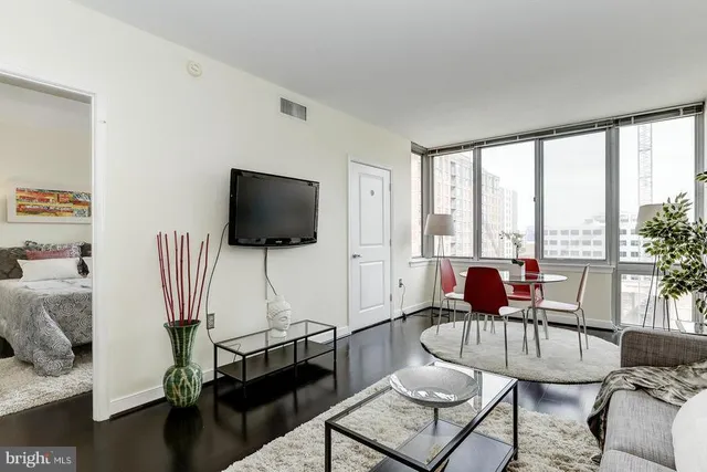 a living room with furniture and a flat screen tv