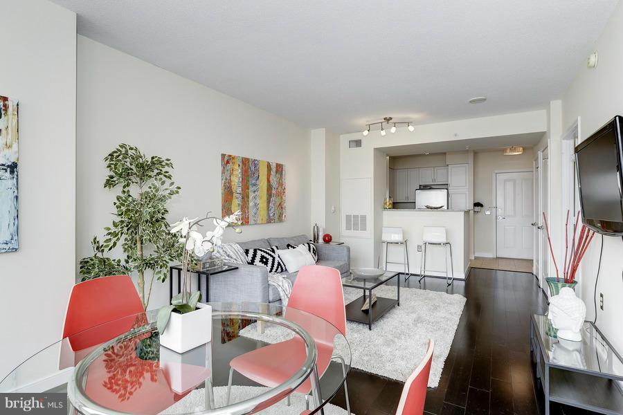 555 Massachusetts Avenue Northwest, Unit 806 Washington, DC 20001 - Photo 6 of 22 a living room with furniture a flat screen tv and a large window
