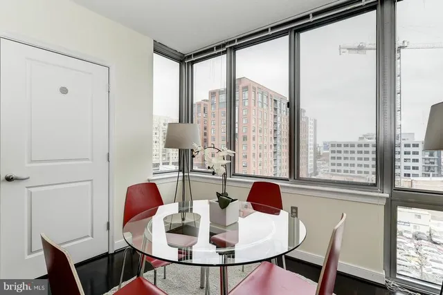 a dining room with furniture and wooden floor