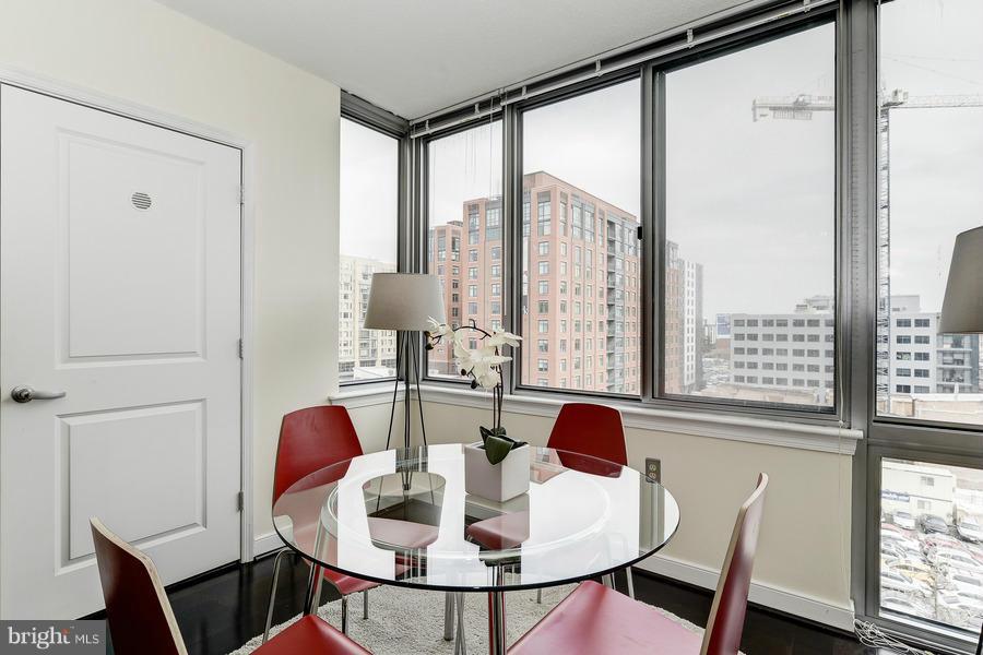 555 Massachusetts Avenue Northwest, Unit 806 Washington, DC 20001 - Photo 7 of 22 a dining room with furniture and wooden floor