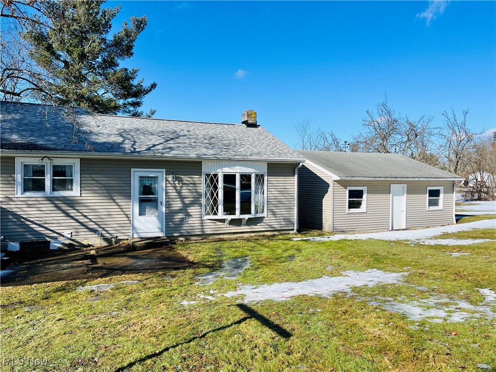 3210 Austinburg Road Ashtabula, OH 44004 - Photo 10 of 48 Back of house featuring a shingled roof and a yard