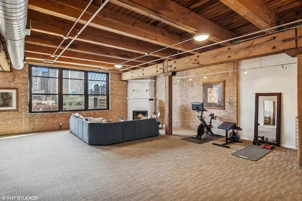 a living room with furniture a flat screen tv and a table