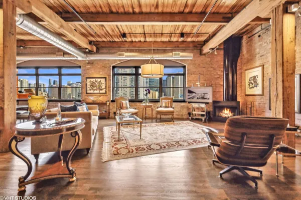 a living room with furniture a wooden floor and next to a window