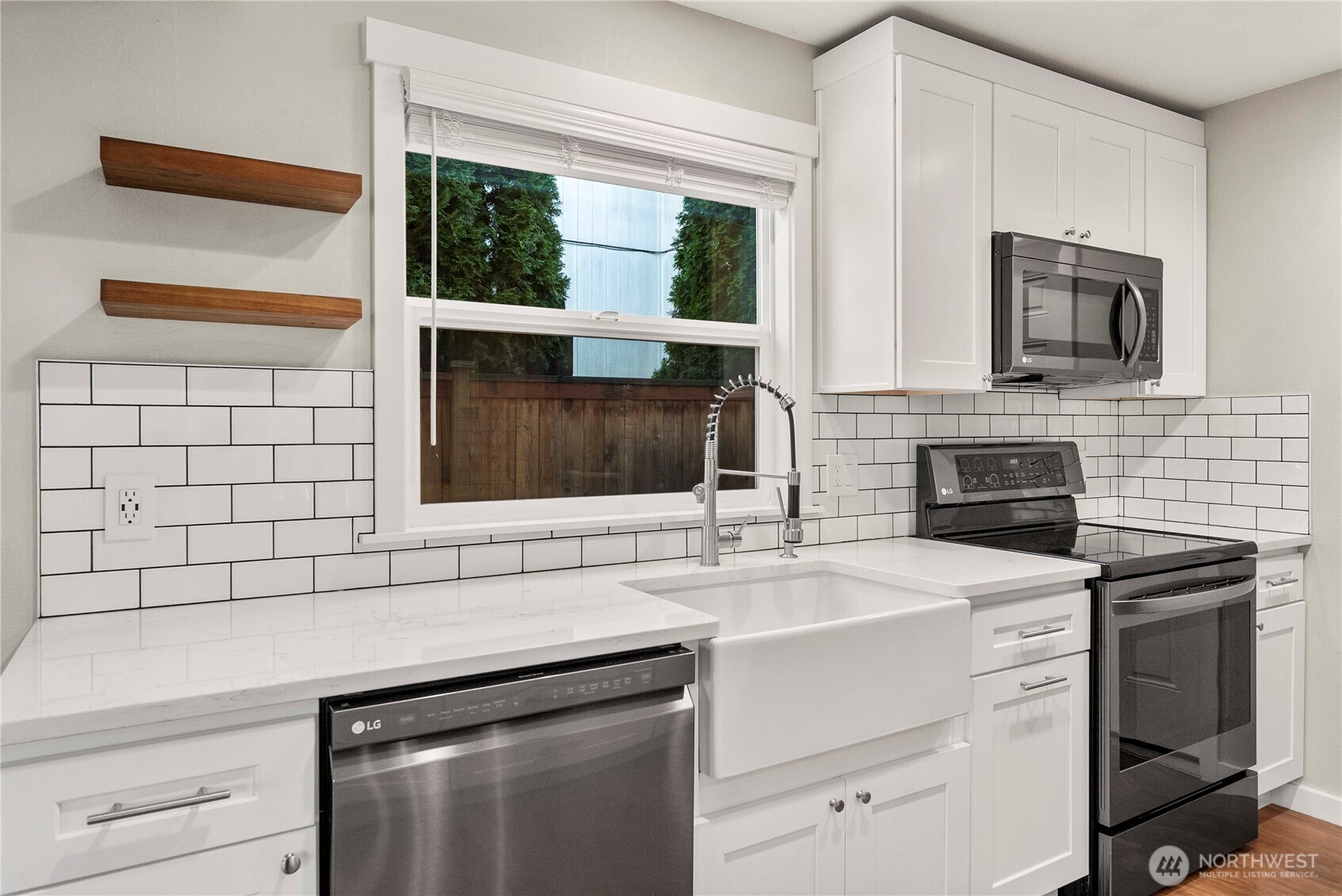 21816 Southeast 269th Street Maple Valley, WA 98038 - Photo 11 of 35 a kitchen with a sink stove and microwave
