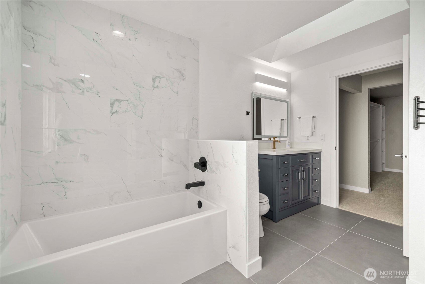 21816 Southeast 269th Street Maple Valley, WA 98038 - Photo 19 of 35 a bathroom with a bathtub a sink a vanity and a shower