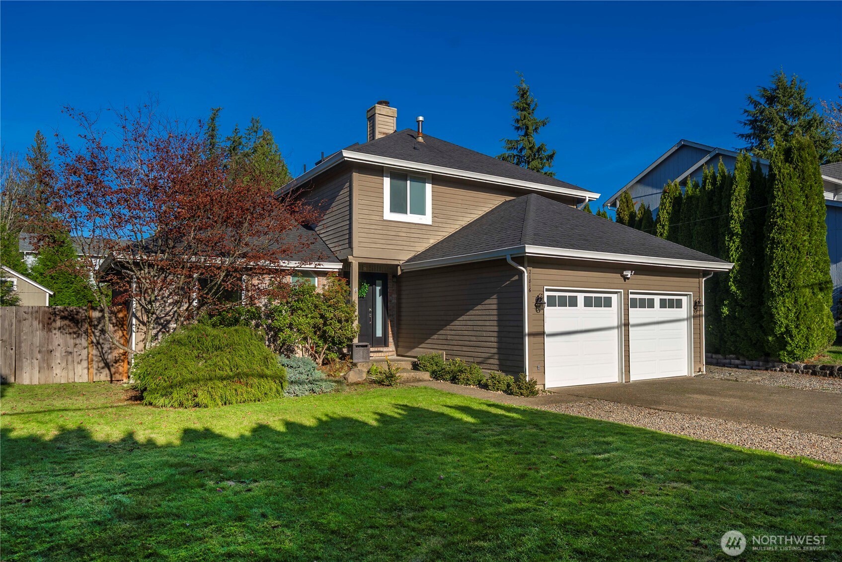21816 Southeast 269th Street Maple Valley, WA 98038 - Photo 2 of 35 a front view of a house with a yard