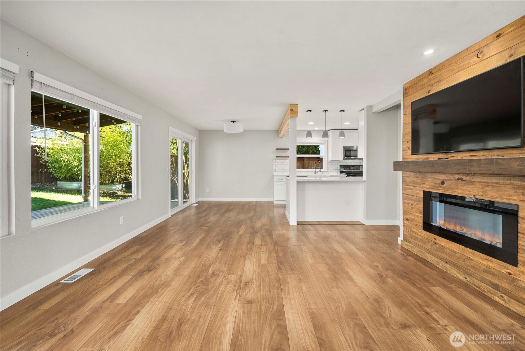 21816 Southeast 269th Street Maple Valley, WA 98038 - Photo 7 of 35 a view of a livingroom with a fireplace wooden floor and windows